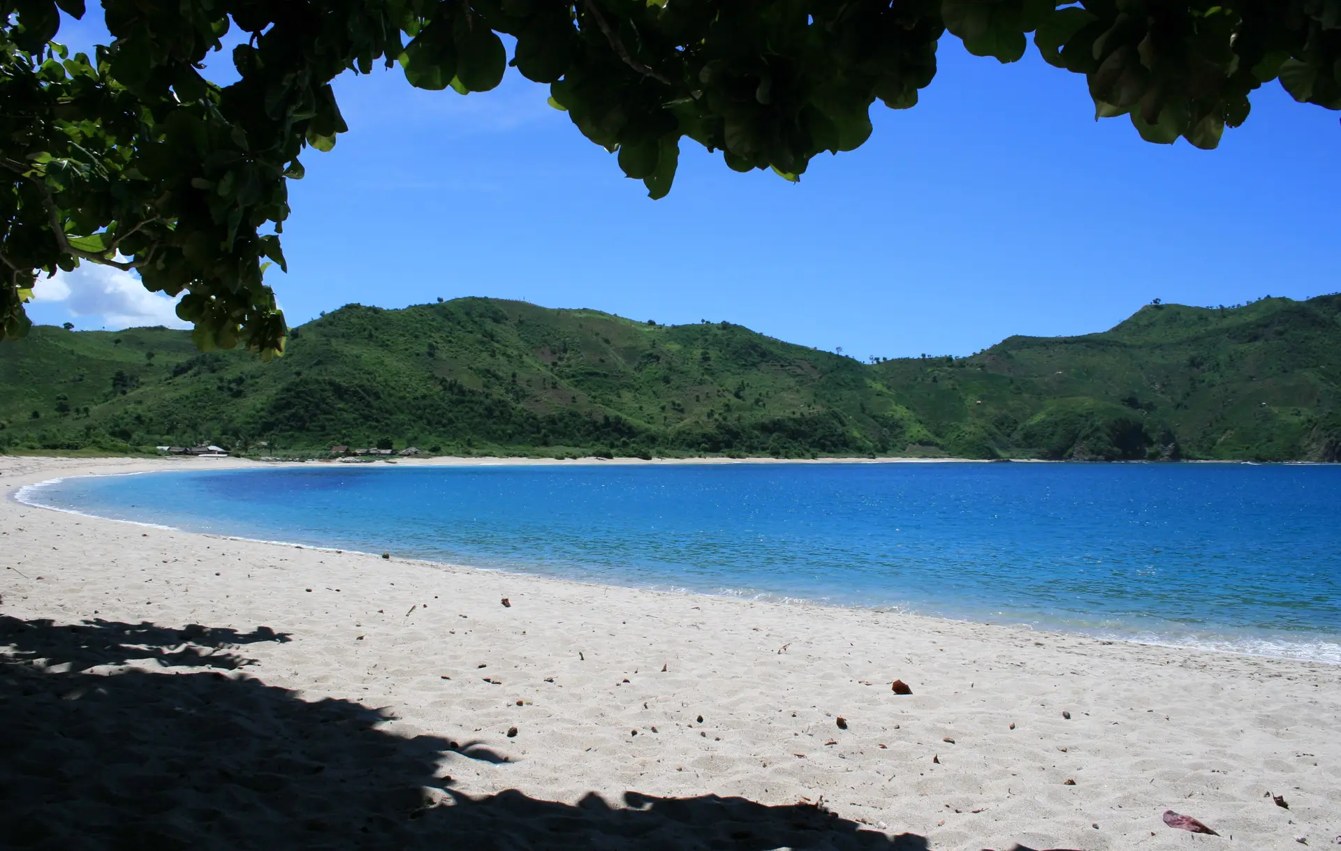 A white sand bay and green hills at Mawun, South Lombok